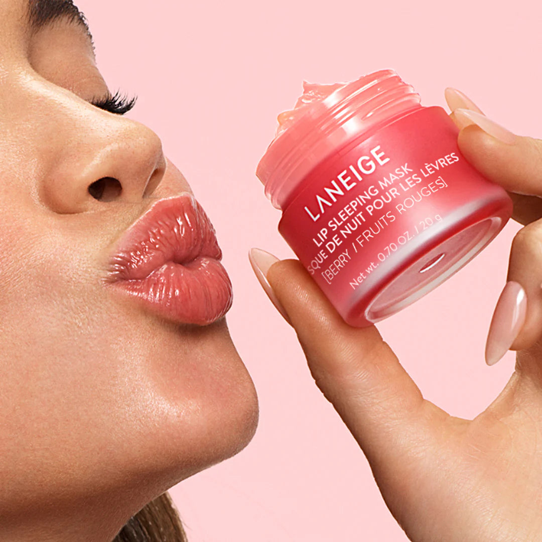Person applying Laneige lip sleeping mask with a pink background, Korean lip care balm for soft lips, LUME